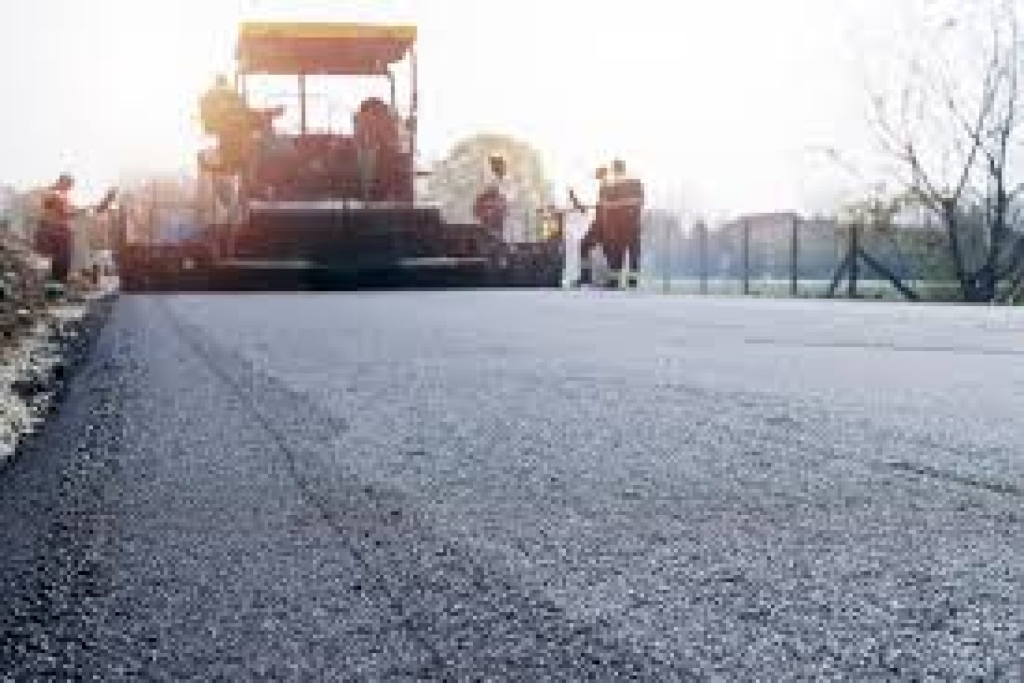workers-placing-new-coating-asphalt-road_342744-601